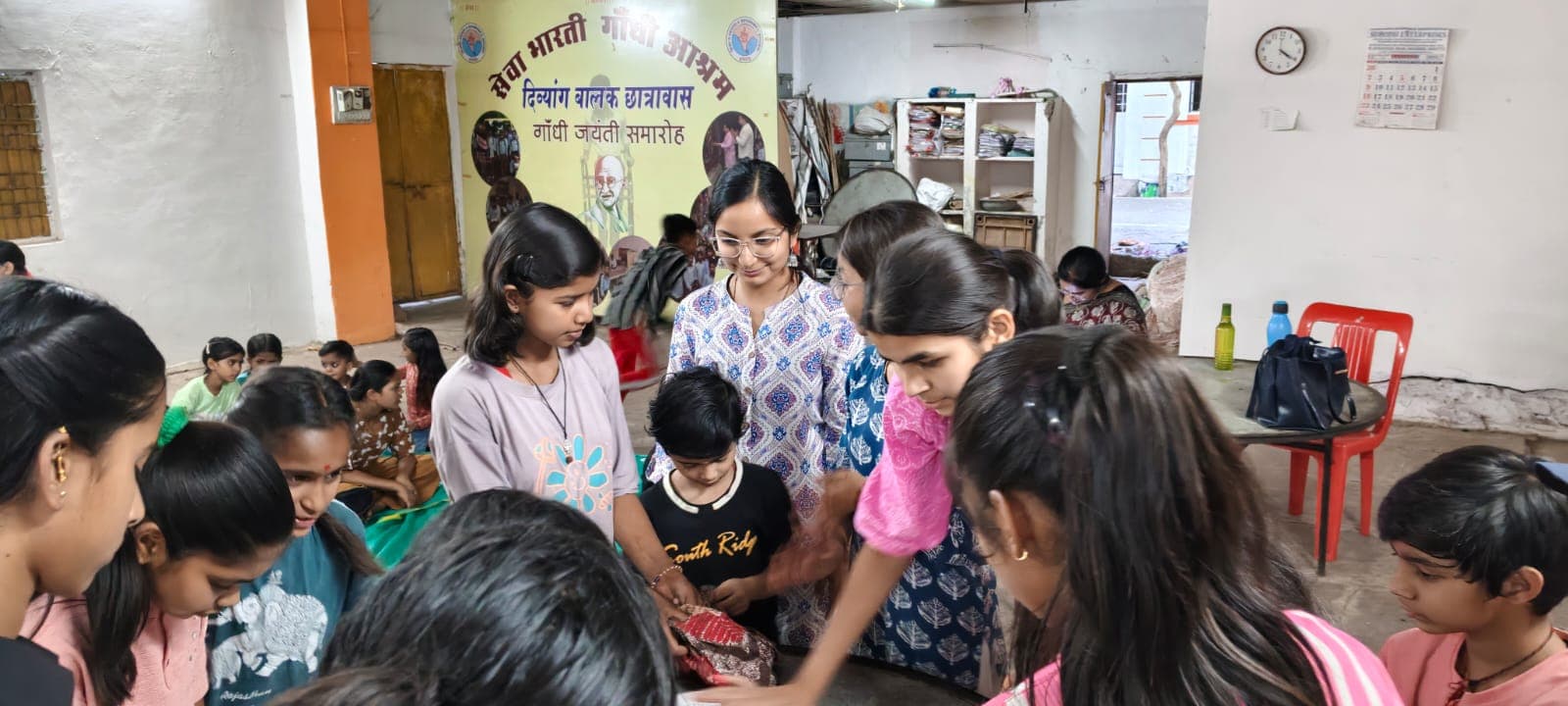 Volunteers and children working together at Seva Bharti Gandhi Ashram