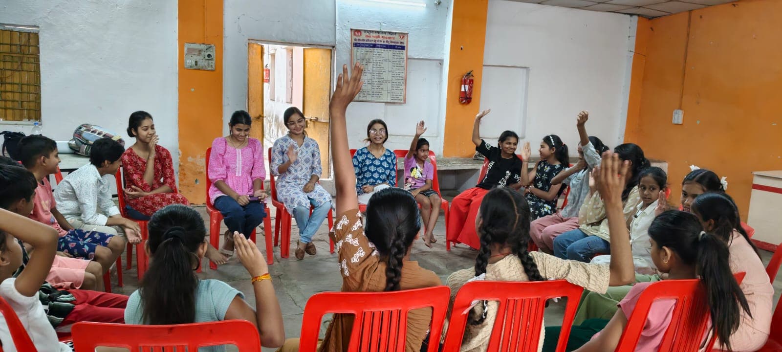 Children raising their hands during a group conversation